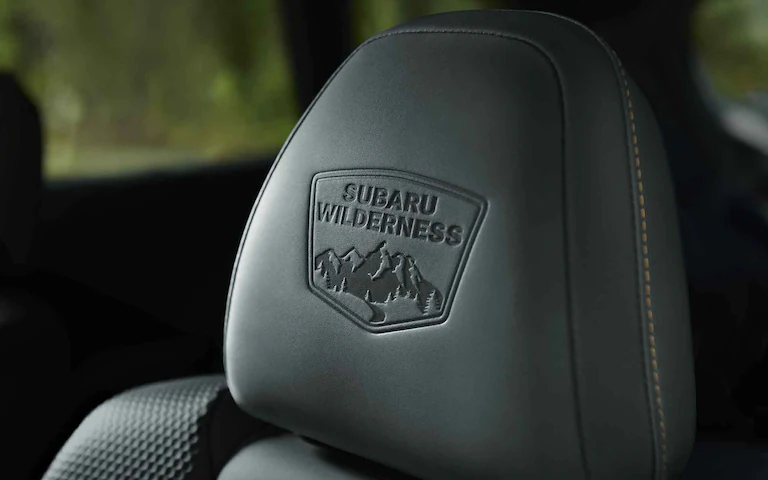 Close up of the Subaru Wilderness badge on the black leather seat of a Subaru Outback