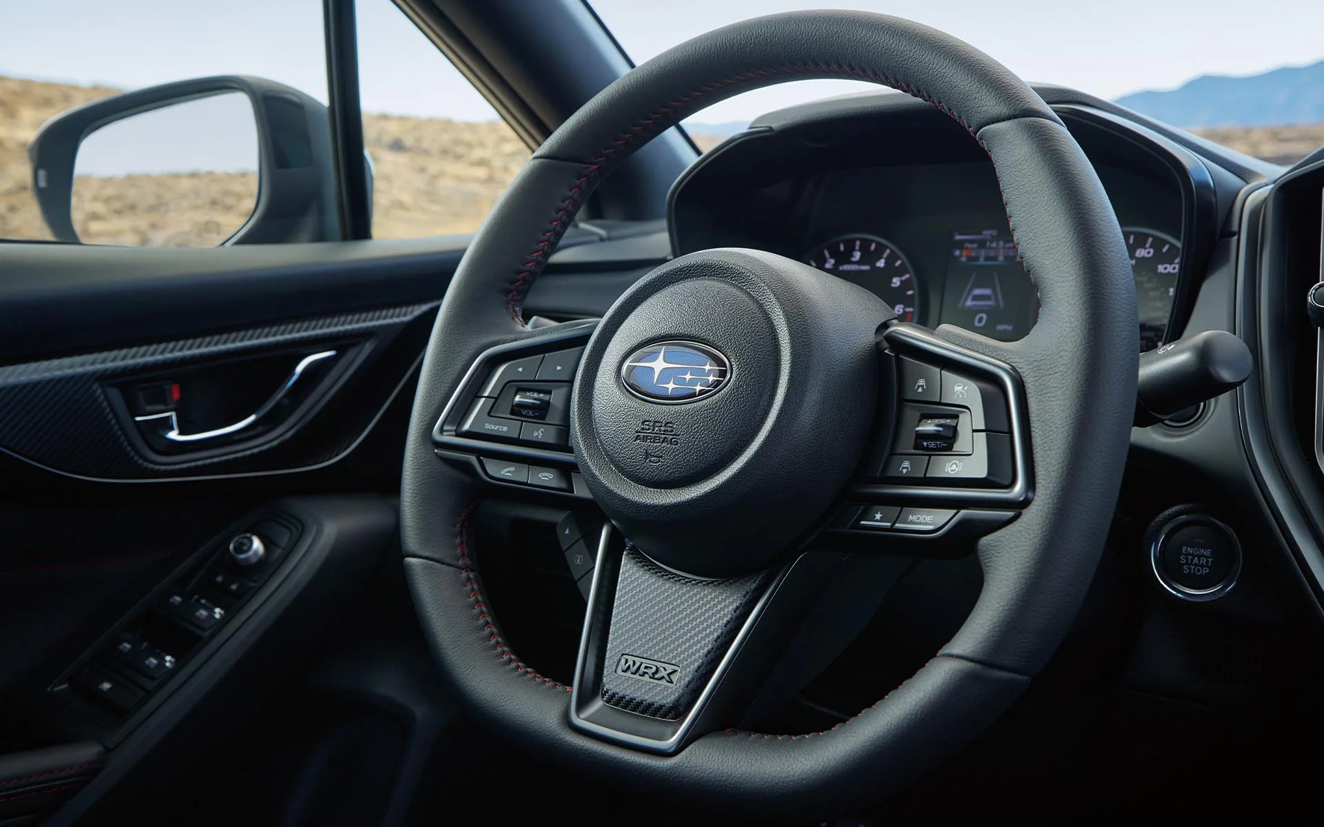 Close up of the D-shaped steering wheel inside a Subaru WRX
