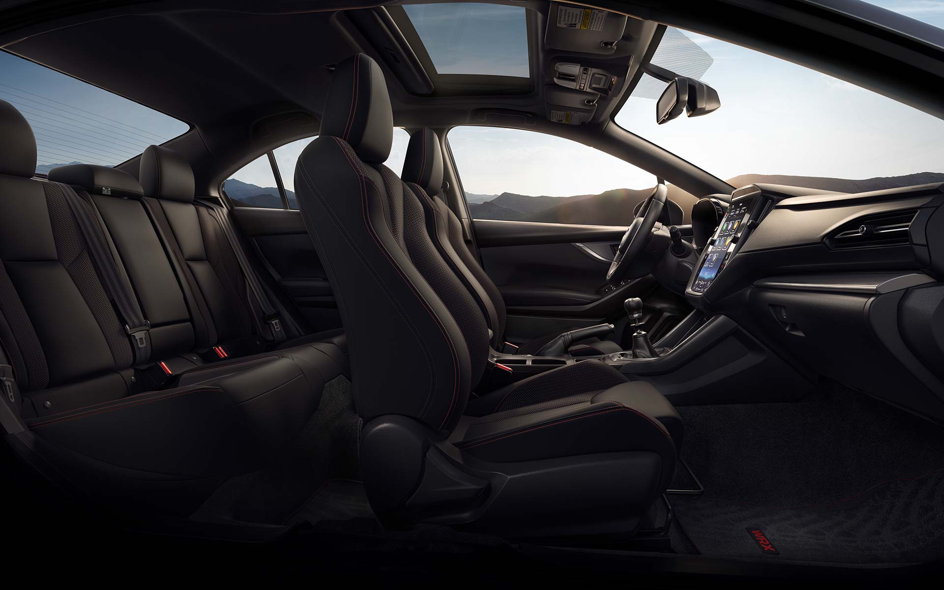 Side view of black cloth seats with red stitching inside a Subaru WRX