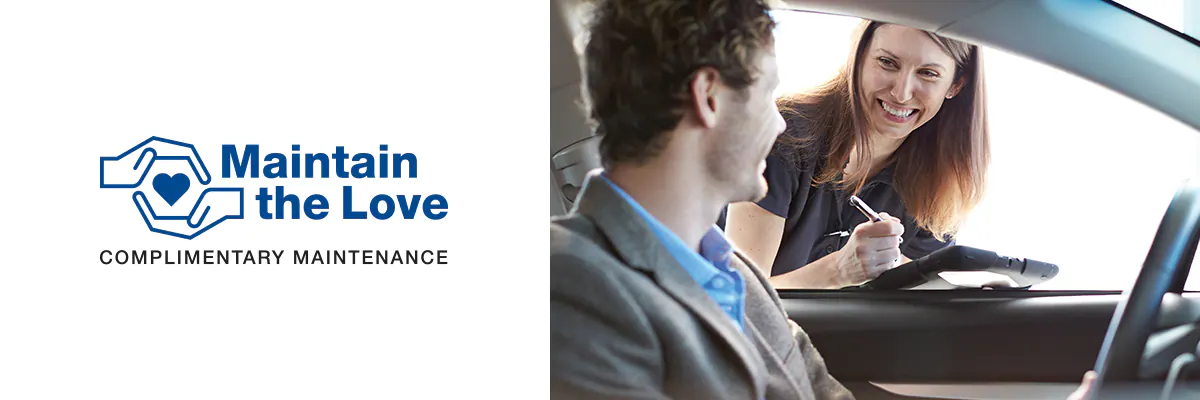 Maintain the Love Logo and image of service representative talking to customer in a Subaru.